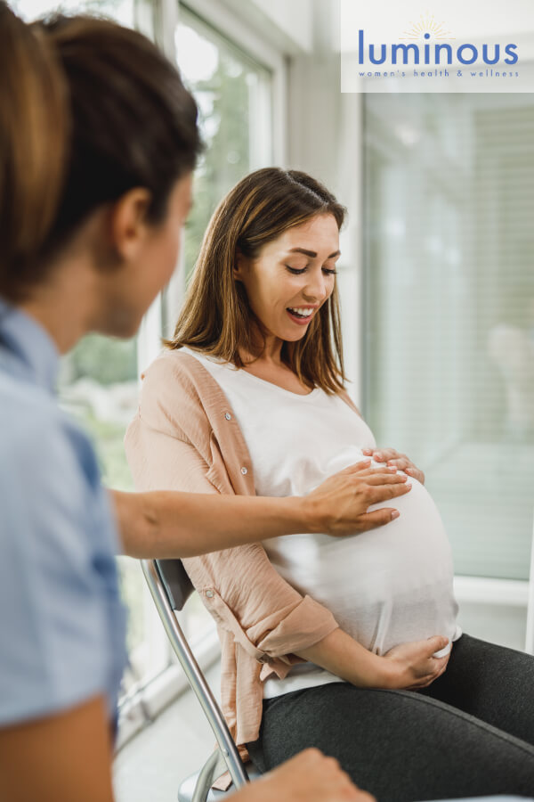 luminous-pregnant-woman-receiving-care-with-logo